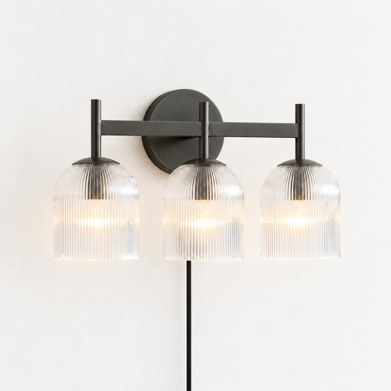 Black ribbed-glass wall sconce, three lights